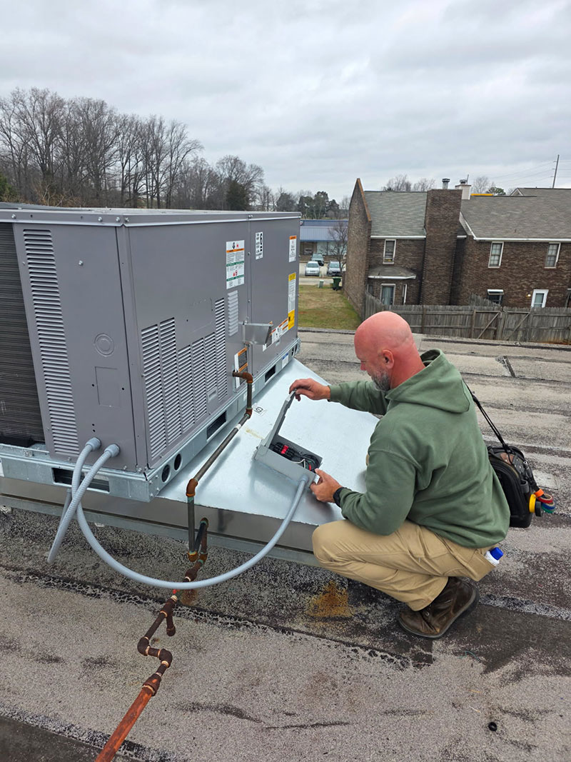 Gatlin's HVAC technician diagnosing an outdoor air conditioning system in Madison Alabama